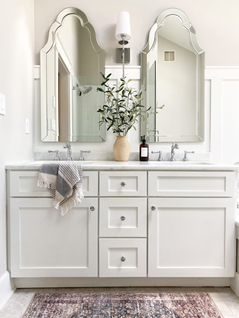 https://myfurnitureroom.com/wp-content/uploads/2023/08/Sherwin-Williams-High-Reflective-White-painted-vanity-marble-look-quartz-countertop-board-and-batten-arched-mirrors-On-the-Rocks-Sherwin.-Kylie-M-Interiors-Edesign-sca-768x1024.jpg